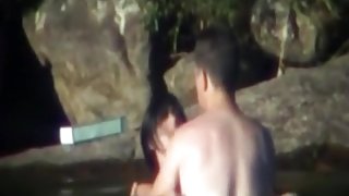 Voyeur tapes a couple having sex in a lake