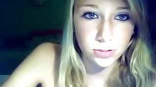 Blonde girl with tanlines plays with her shaved pussy on a chair